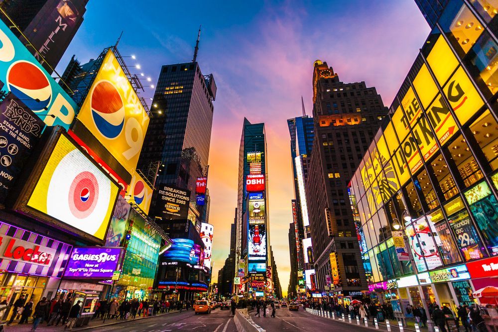 Bright advertising billboards in Times Square at dusk